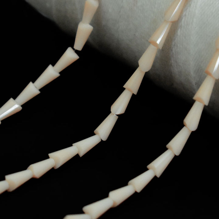 Cream color cone faceted beads