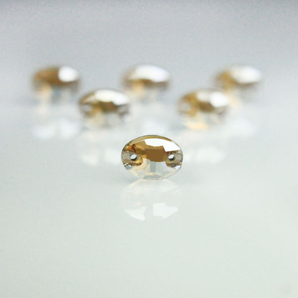 EMBGS4925 (7x10 MM Golden Shadow Color Flat Back Oval Glass Crystal)